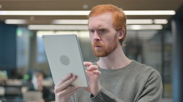 Portrait of Young Man Having Loss on Tablet in Office