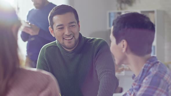 Cheerful Colleagues Chatting at Work