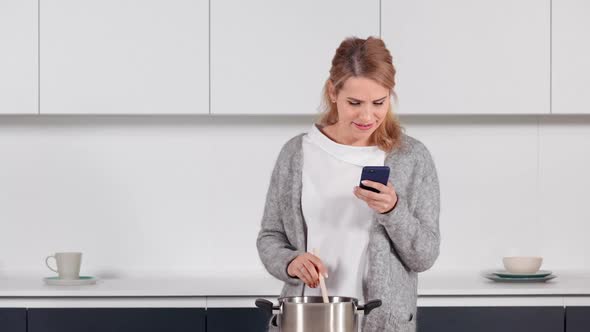 Cheerful Female Cooking at Home