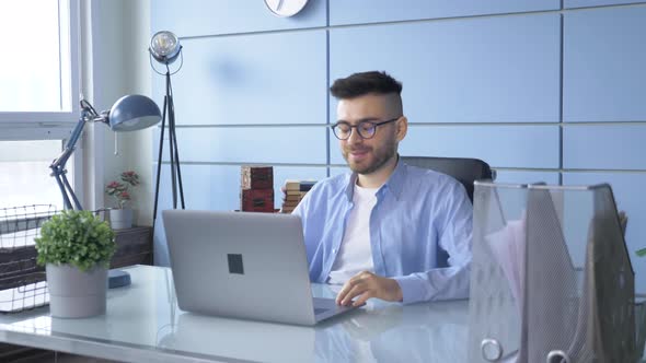 Man Person Using Video Conferencing technology in Home Office for video call with colleagues