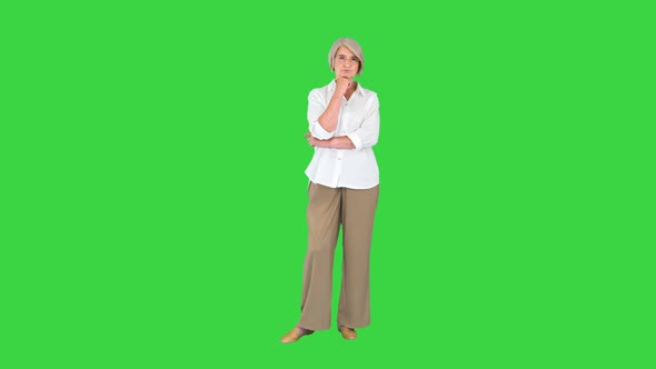 Business Lady in Glasses Thinking and Having an Idea Pointing Finger Up on a Green Screen Chroma Key