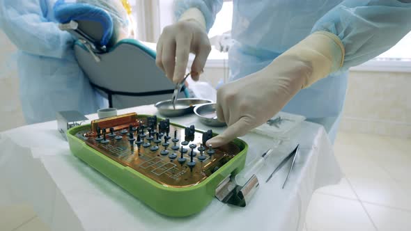 Dentist is Picking Medical Tools to Work on the Patient