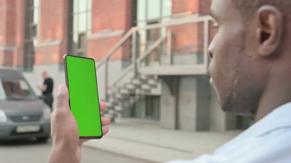 African Man Walking with Green Screen Smartphone