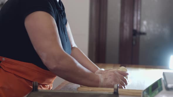 A Cook Is Kneading the Dough By Hands