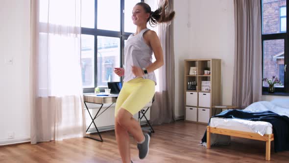 Smiling Teenage Girl Running on Spot at Home