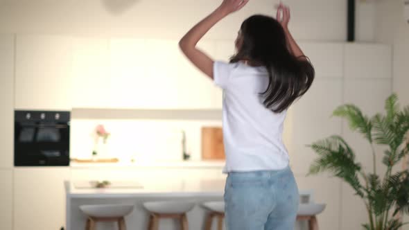 Cheerful Happy Caucasian Brunette Woman in Basic White Tshirt Dancing to Favorite Music Having Fun