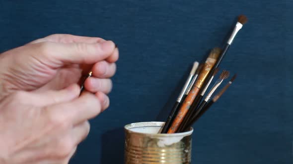 artist holds art brushes