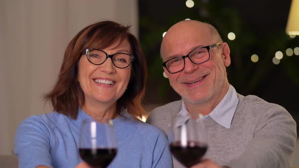 Happy Senior Couple with Glasses of Red Wine