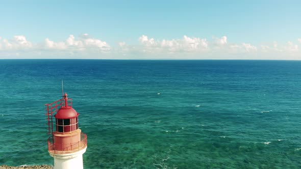 Turquoise Sea Waters and an Island with a Beacon on It