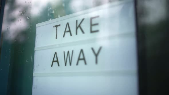 Lightbox with As Sign Take Away Behind a Glass Door of the Cafe. We're Open Again After Quarantine