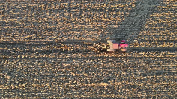 Aerial View of Agricultural Field Modern Red Tractor Plowing Land