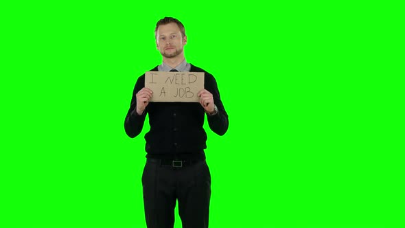 Businessman with a Cardboard Sign That Asks About Desire To Find a Job. Green Screen