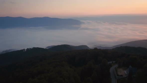 Aerial view of a foggy valley at sunset