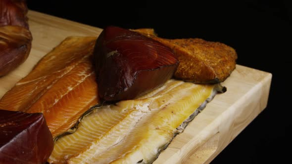 Rotating Shot of A Variety of Delicious, Premium Smoked Meats on A Wooden Cutting Board