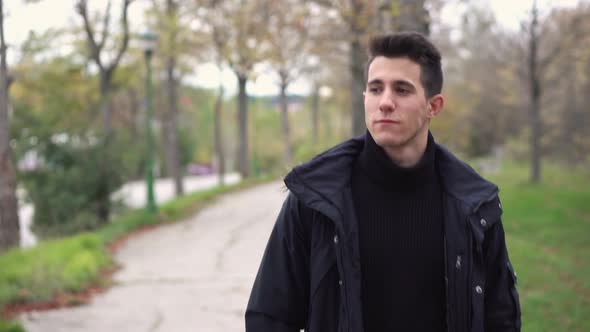  A Young Man Walks Through the Autumn Park.