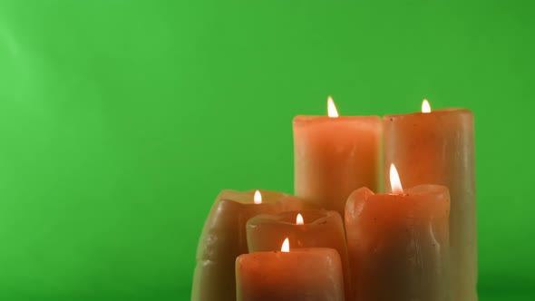 Burning Wax Candles on Green Chroma Key Background