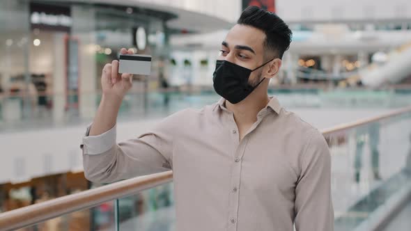 Arabian Indian Hispanic Man in Medical Mask Standing with Purchases