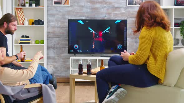 Back View of Young Woman Playing Video Games on Tv