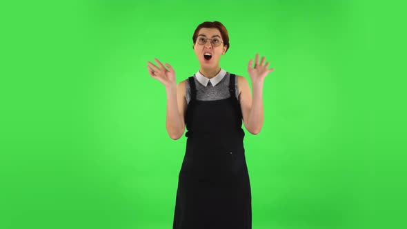 Funny Girl in Round Glasses Is Pretending To Be Scared. Green Screen