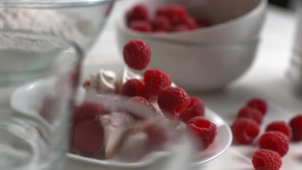 Raspberries falling onto dessert in super slow motion, shot on Phantom Flex 4K