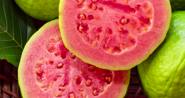 closeup on red guavas cut in basket