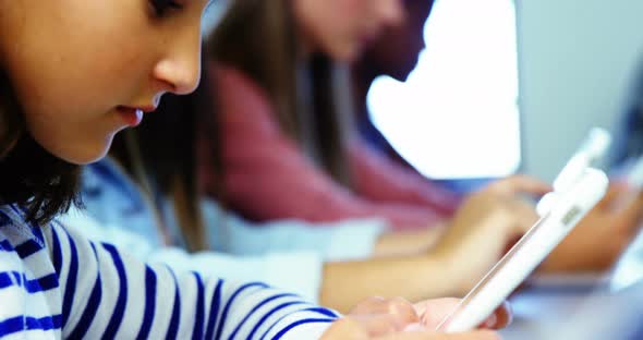 Students using digital tablet in classroom