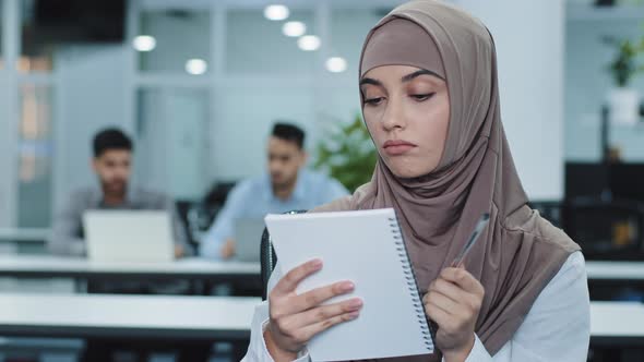 Thoughtful Millennial Indian Woman in Hijab Looking Aside Planning Preparing for Meeting