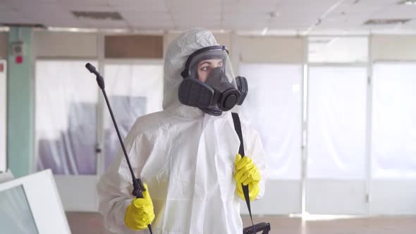 Portrait of the Exterminator in Overalls with a Sprayer