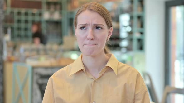 Portrait of Upset Young Woman Crying at the Camera