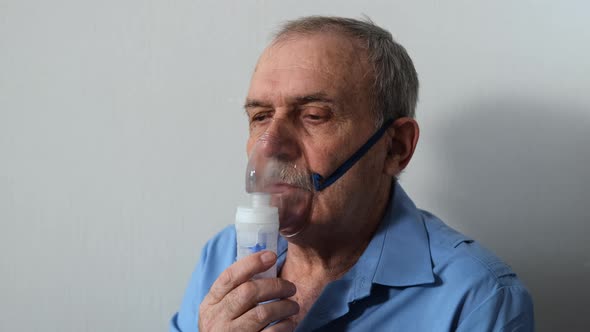 Senior Man Does Inhalation Therapy Nebulizer