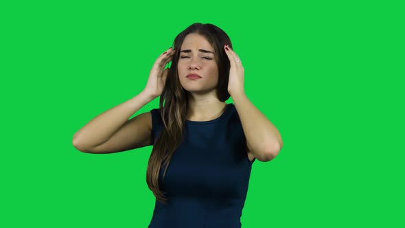 Girl having a headache in front of a green screen