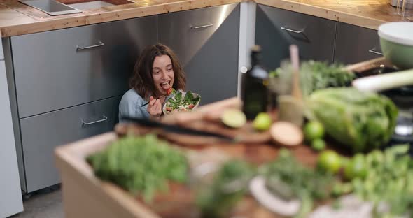 Woman with Healthy Green Food on the Kitchen