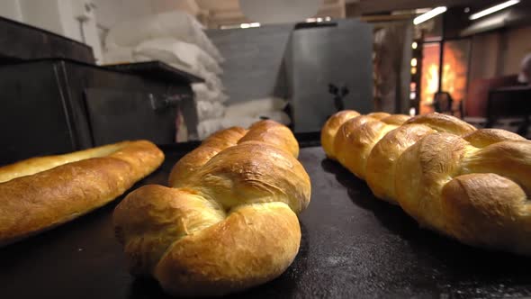 baked pastries in form of rolls and bread lie on table against background bakery