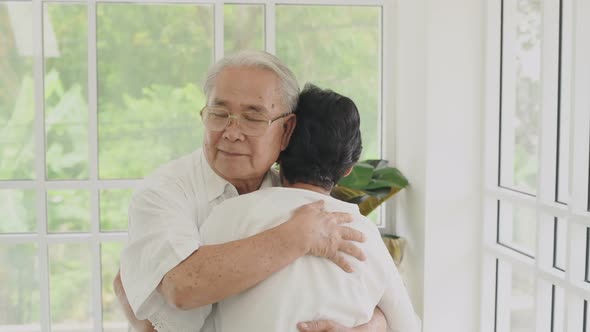 Family concept. Asian old couple hugging indoors. 4k Resolution