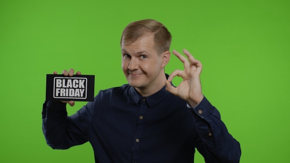 Happy Man Holding Black Friday Inscription, Showing Ok Sign. Guy Rejoicing with Good Sale Discounts