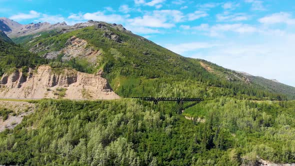 4K Drone Video of Train Trestle bridge and Mountains Rising above the Chulitna River near Denali Nat