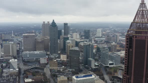 Drone shot above Midtown Atlanta on a cloudy day after a storm. Pushing in towards Downtown near Ban