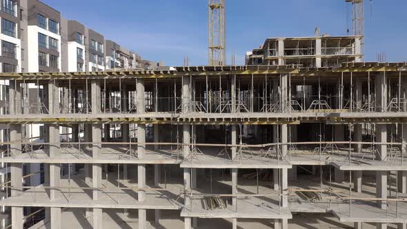 Building crane and monolituc building under construction. Construction site