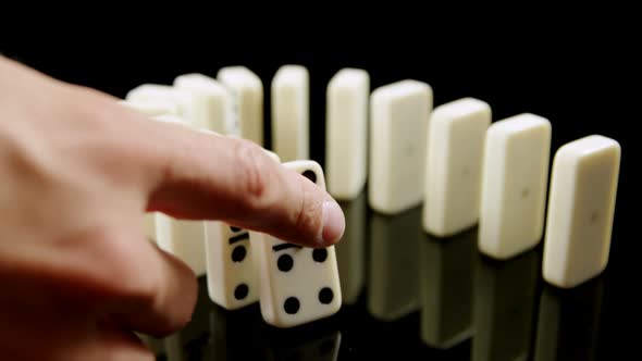 Person touching dice on black background 4k