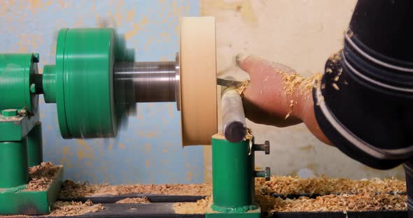 Closeup of carpenter turning wood on a lathe