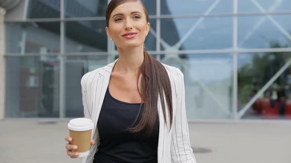 Business Woman With Coffee And Suitcase Walking Near Airport