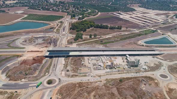 Aerial footage of large highway construction project with tunnels and bridges