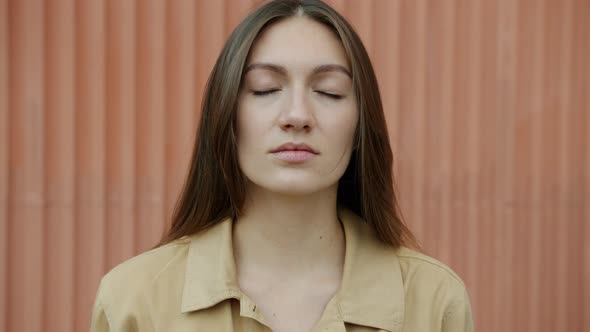 Slow Motion Portrait of Peaceful Young Woman Meditating Standing Outdoors with Closed Eyes