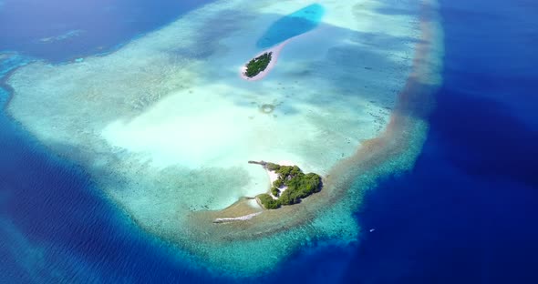 Wide angle birds eye abstract view of a summer white paradise sand beach and aqua blue ocean backgro