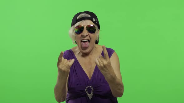 Elderly Woman in Sunglasses Shouts with a Smile and Showing Tongue. Chroma Key