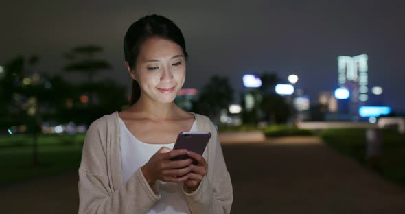 Woman use of cellphone at night