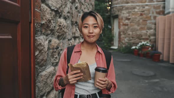 Portrait of Young Asian Woman with Street Food Outdoors