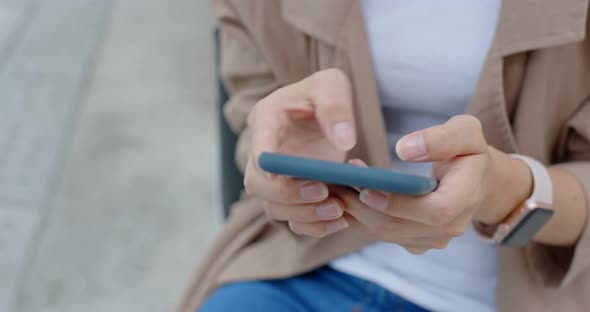 Woman use of mobile phone in city