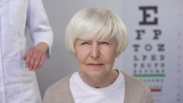 Elderly Lady Visiting Friendly Optometrist, Checking Vision, Risk of Cataract