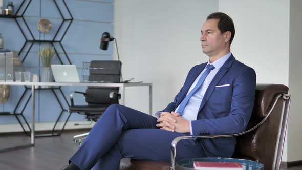 Relax Businessman Sitting on Sofa in Office